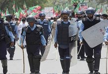 PTI workers clash with police, set picket on fire