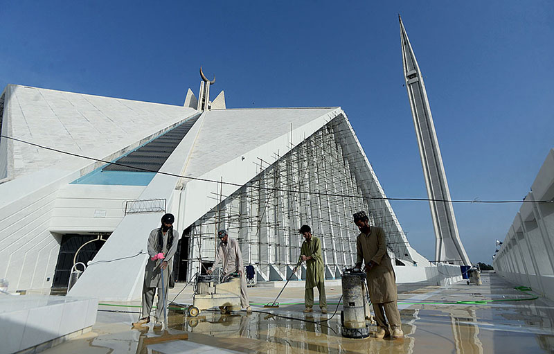 Labourers polishing the marble during the maintenance work of Faisal Mosque.