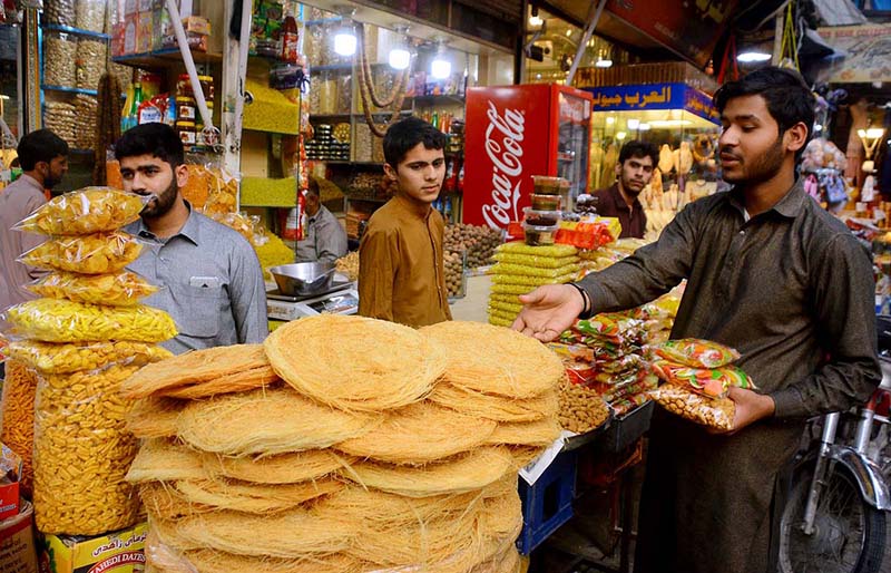 Vendor selling and displaying different food items to attract the customers Sadar Bazar during the holy fasting month of Ramazan.