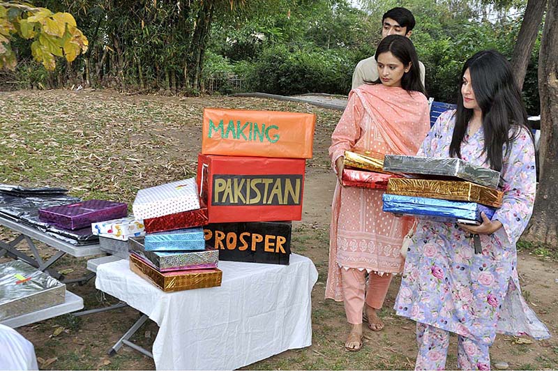 Volunteers are distributing Eid gift among to street children at Rawal town Local Park