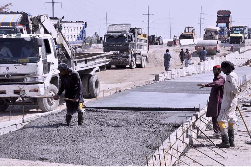 Labourers busy in construction work of IJP Road with the help of Heavy machinery during development work in the city