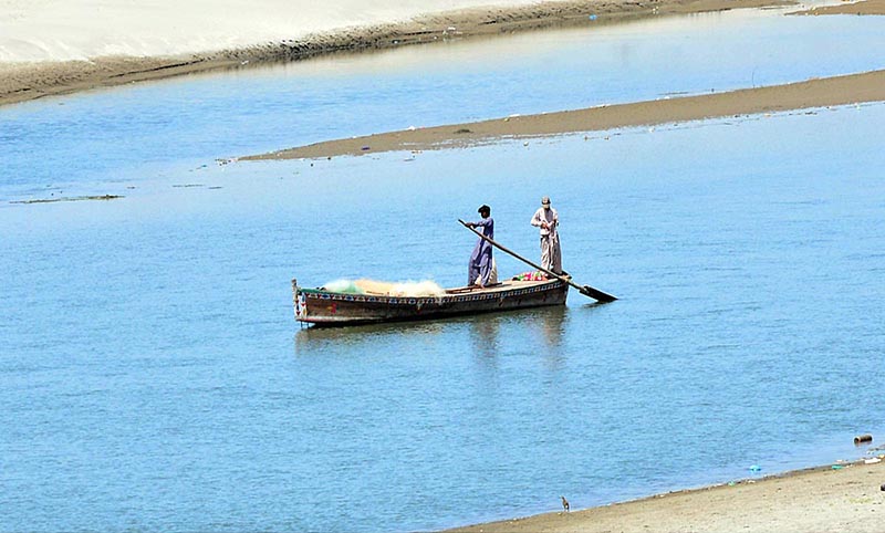 Fisherman fishing on the boat at Indus River.