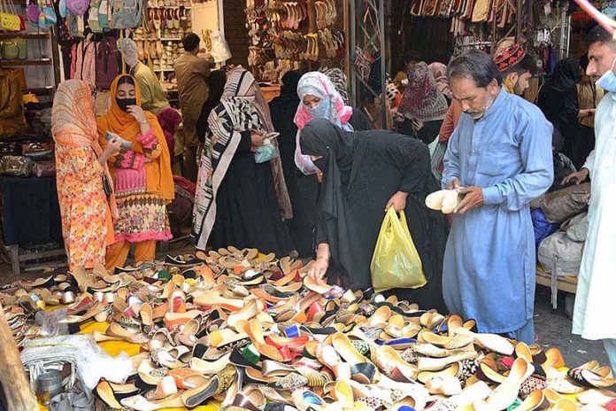 Women busy in purchasing shoes during preparation of upcoming Eid ul Fitr