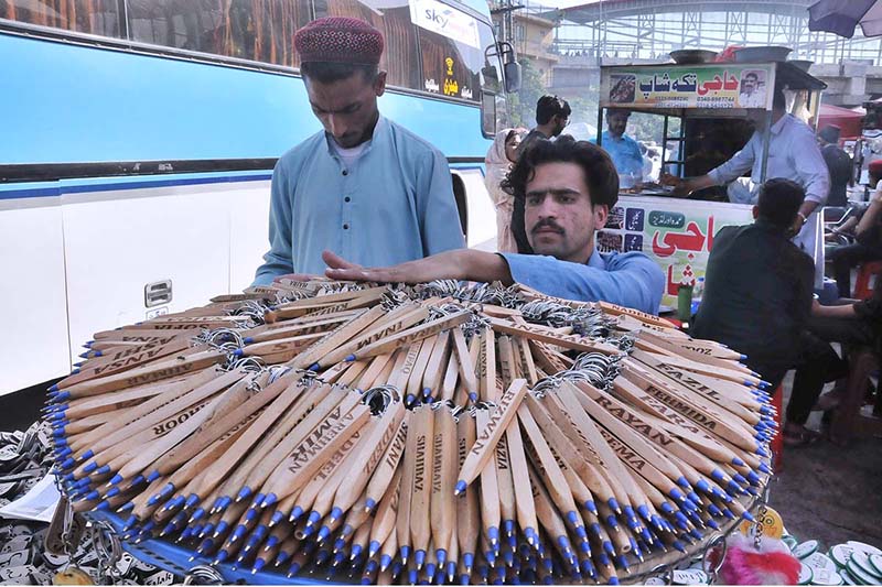 A vendor displays pens at the bus station attracting the people coming back to the city after spending Eid ul Fitr holidays in their hometowns