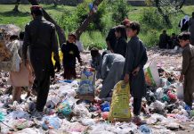 Gypsy children are searching valuables from a garbage near Khanna Pul area