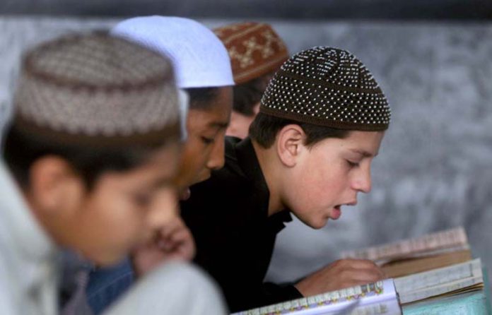 Madrassa Students reciting Holy Quran during the Holy fasting month of Ramazan ul Mubarak at madrassa Chiragh ud Din Shah.