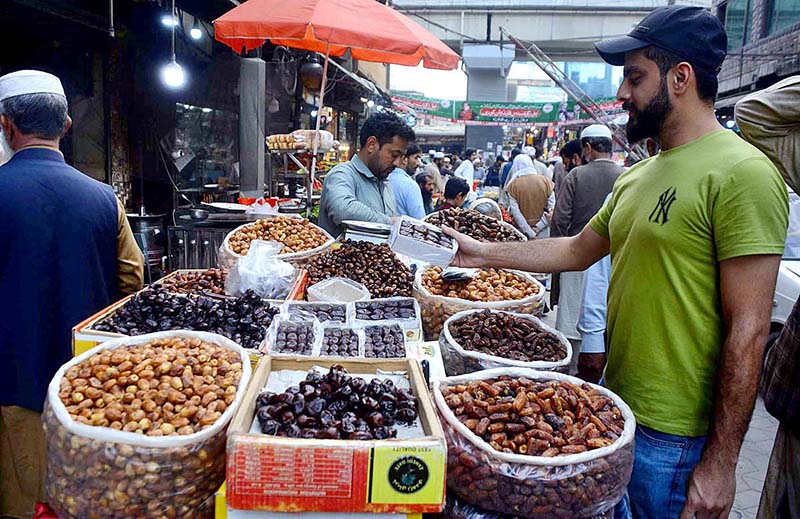 Customer selecting and purchasing dates from a roadside vendor during the holy fasting month of Ramazan.