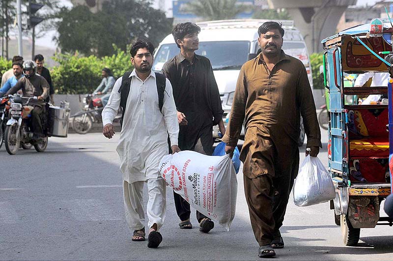 People along with their luggage at General Bus Stand to leave for their home town to celebrate the Eid-ul-Fitr with their loved ones