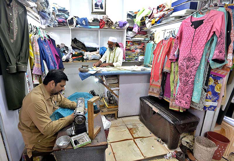 Tailors busy in stitching clothes of customers ahead of Eid-ul-Fitr at Aabpara.