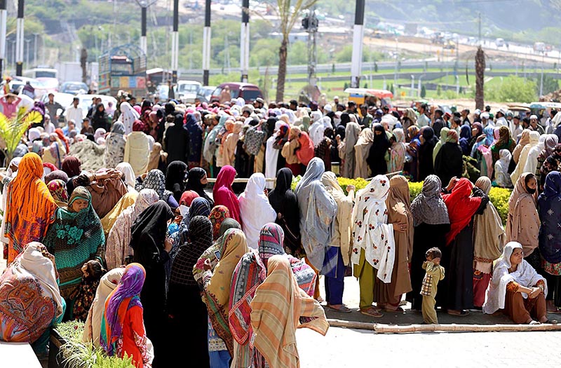 A large number of women standing in queue for getting free flour bags under Ramzan Package in Federal Capital.