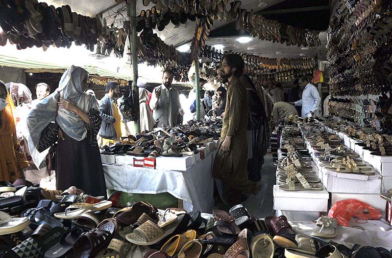 People purchasing shoes at H-9 weekly bazar