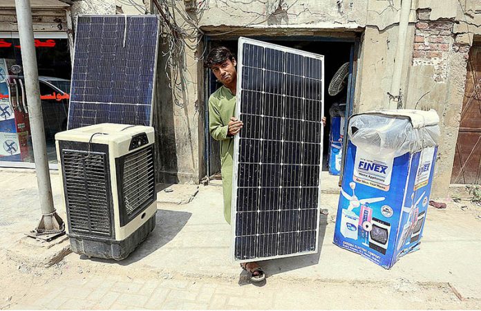 Vendor displaying solar panels to attract the customers at his workplace
