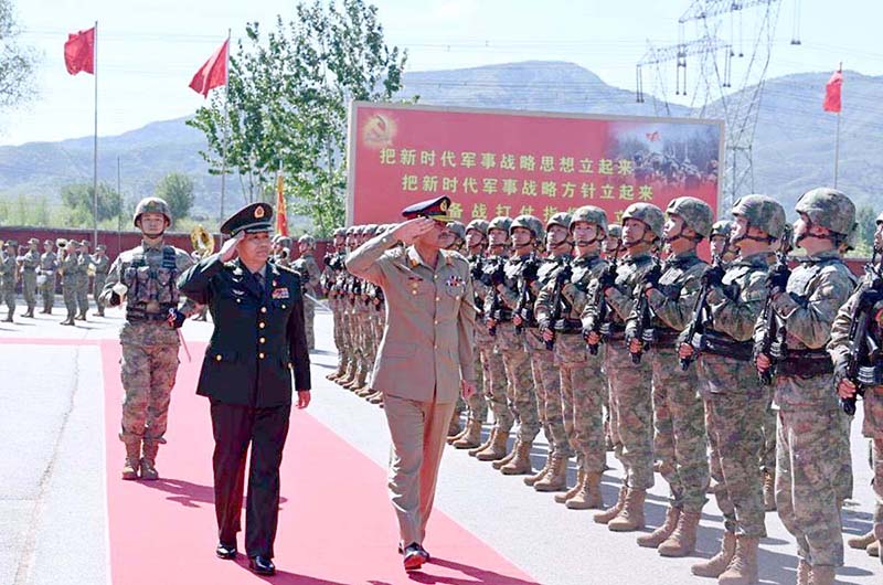 COAS Gen Asim Munir with Chinese counterpart salute as they inspect at the PLA Army Headquarters after his warm welcome during his four-day official visit in China