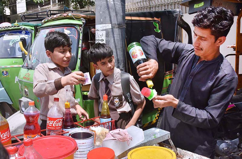 The students are buying ice gola from a vendor
