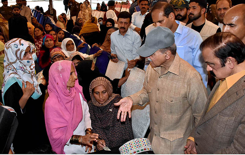 Prime Minister Muhammad Shehbaz Sharif is interacting with deserving people during his visit to free flour distribution Center at Iqbal Stadium.