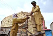 Labourers busy in loading bricks on tractor trolley at a kiln as the world marks International Labour Day. May 1st, International Workers' Day, commemorates the historic struggle of working people throughout the world. In 1884, the Federation of Organized Trades and Labour Unions passed a resolution stating that eight hours would constitute a legal day's work from and after May 1, 1886