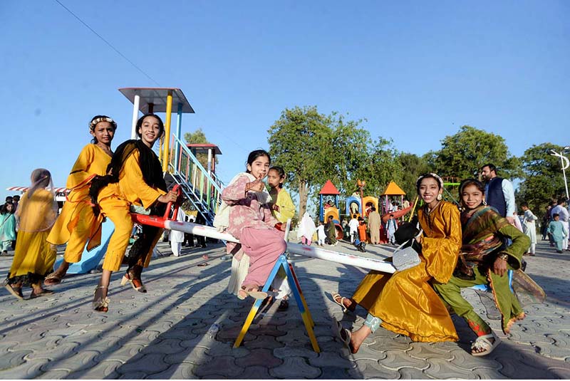 Children enjoying Seesaw at Sher Khan Shaheed Amusement Park on the 2nd day of Eid-ul Fitr celebrations