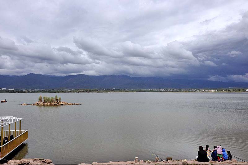 An attractive view of thick clouds hovering over the skies through Rawal Lake