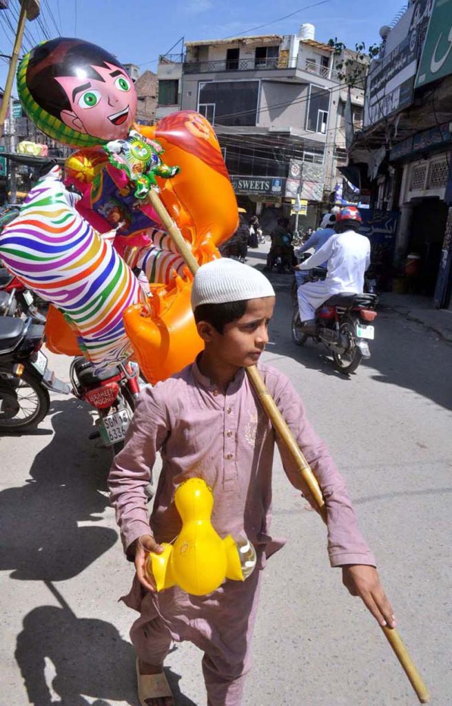 A young street vendor selling beautiful balloons and toys at Gole chowk.
