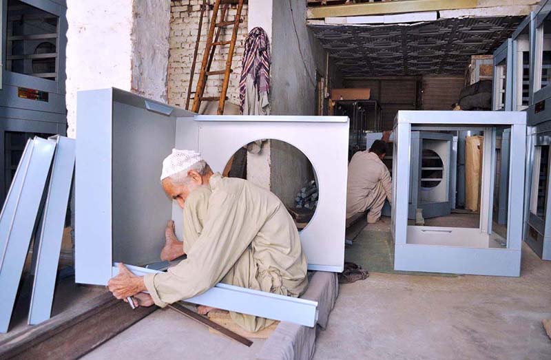 A worker is making water air room cooler on his work shop at Porani Pull satellite town.