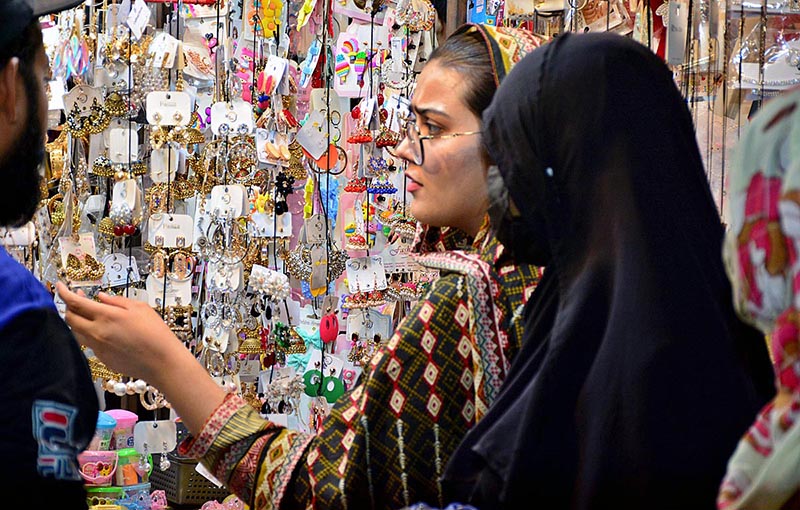 Women busy in selecting artificial jewelry for preparation of upcoming Eid ul Fitr at Latifabad