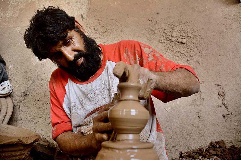Laborer busy in making clay pots at his workplace being observed across the phandu area connection with Labour Day as the world marks International Labour Day. May 1st, International Workers' Day, commemorates the historic struggle of working people throughout the world. In 1884, the Federation of Organized Trades and Labour Unions passed a resolution stating that eight hours would constitute a legal day's work from and after May 1, 1886