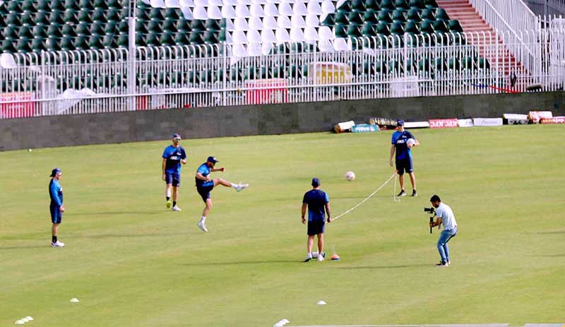 Pakistani and New Zealand cricket players taking part in a practice session at Pindi Cricket Stadium
