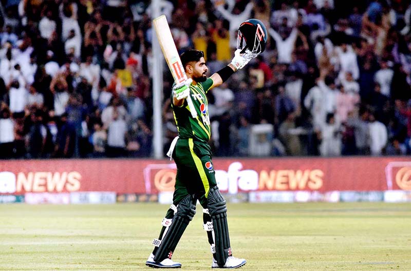 Pakistani Skipper Babar Azam waving bat to celebrate his century score during the 2nd Twenty20 match between Pakistan and New Zealand at the Gaddafi Cricket Stadium