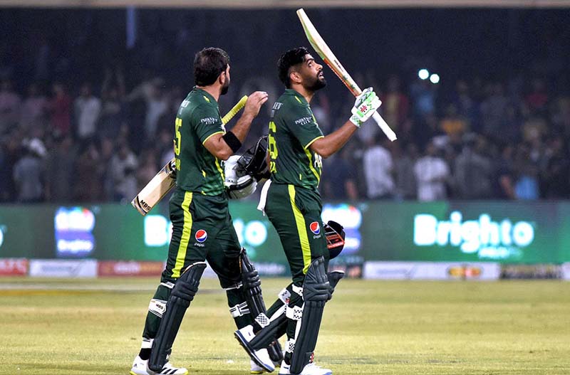 Pakistani Skipper Babar Azam waving bat to celebrate his century score during the 2nd Twenty20 match between Pakistan and New Zealand at the Gaddafi Cricket Stadium