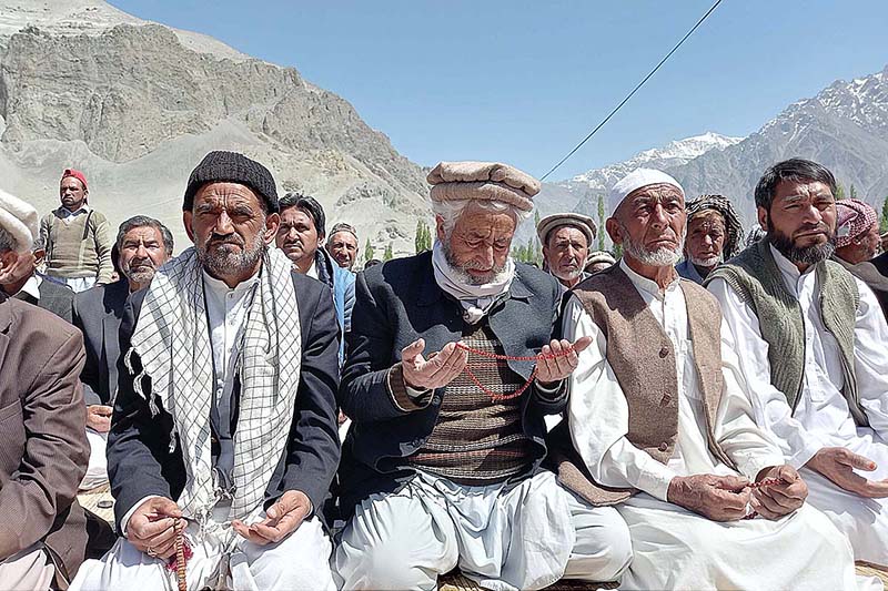 An elderly man is offering dua after Namaz-e-Jumma at Eidgah Skardu