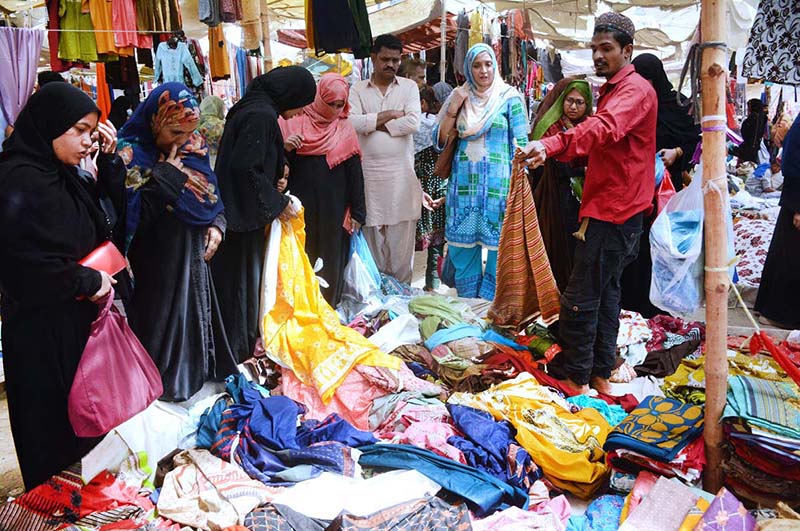Women purchasing clothes at Lines Area Sasta Bazar during holy month of Ramazan