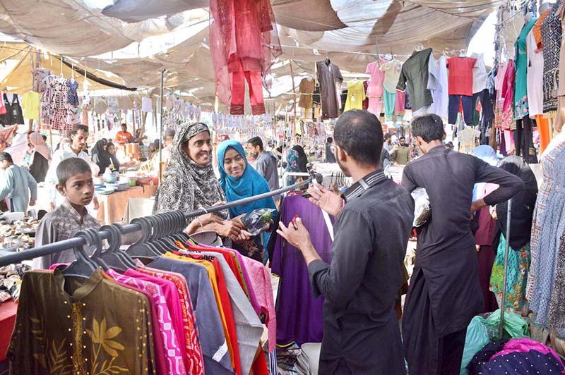 Women purchasing clothes at Lines Area' Sasta Bazar ahead of Eid ul Fiter celebrations