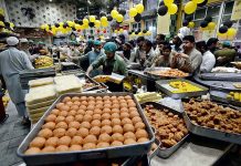 People busy in purchasing sweets at a shop in preparation for the upcoming Eid-ul-Fitr celebrations