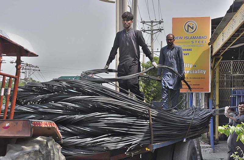 Worker unloading iron bars as the world marks International Labour Day. May 1st, International Workers' Day, commemorates the historic struggle of working people throughout the world. In 1884, the Federation of Organized Trades and Labour Unions passed a resolution stating that eight hours would constitute a legal day's work from and after May 1, 1886