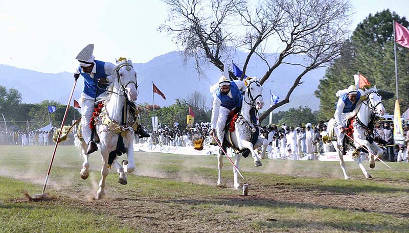 Participants tries to pierce target with lance during Tent-Pegging Riders Championship at Fatima Jinnah F-9 Park