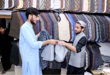 A man buying waistcoat at Abdul Sattar Road in preparation of Eidul Fitr