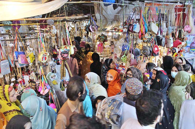 A woman purchasing artificial jewelries at Hashmi Market in preparation of Eid-ul Fitr Quetta