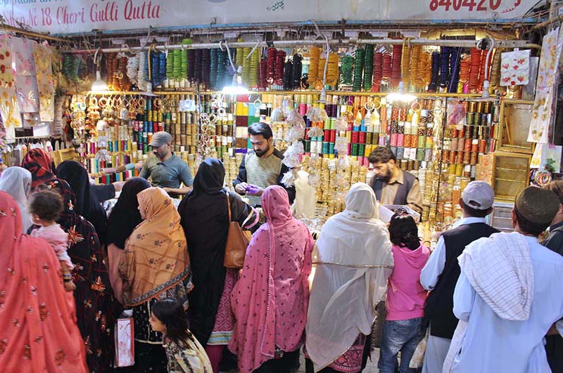 A woman purchasing artificial jewelries at Hashmi Market in preparation of Eid-ul Fitr Quetta