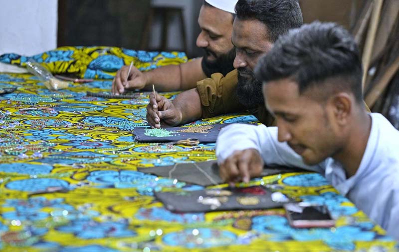 Workers busy in embroidery work on traditional women cloth as per demand of customers for celebration of upcoming Eid-ul Fitr