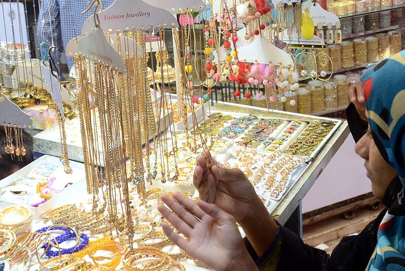 A woman purchasing artificial jewelries in preparation of Eid-ul Fitr