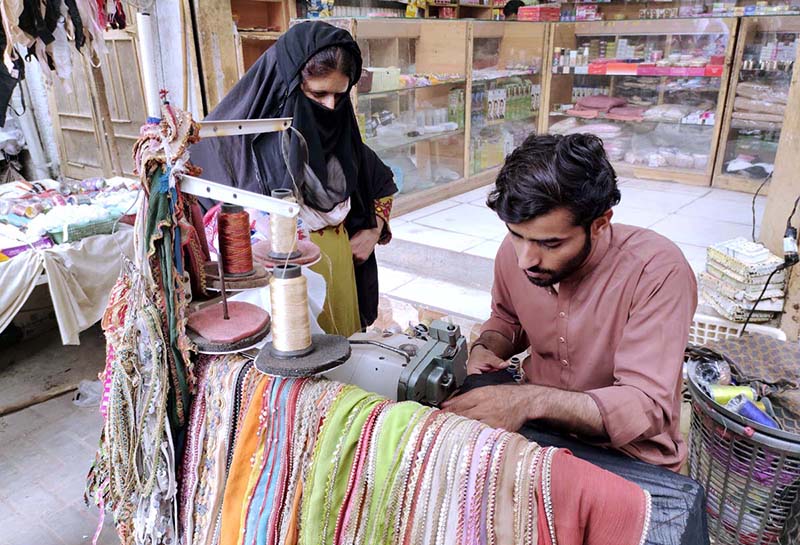 A skilled worker making embroidery work on ladies wear at his workplace in connection with upcoming Eid-ul-Fitr festival