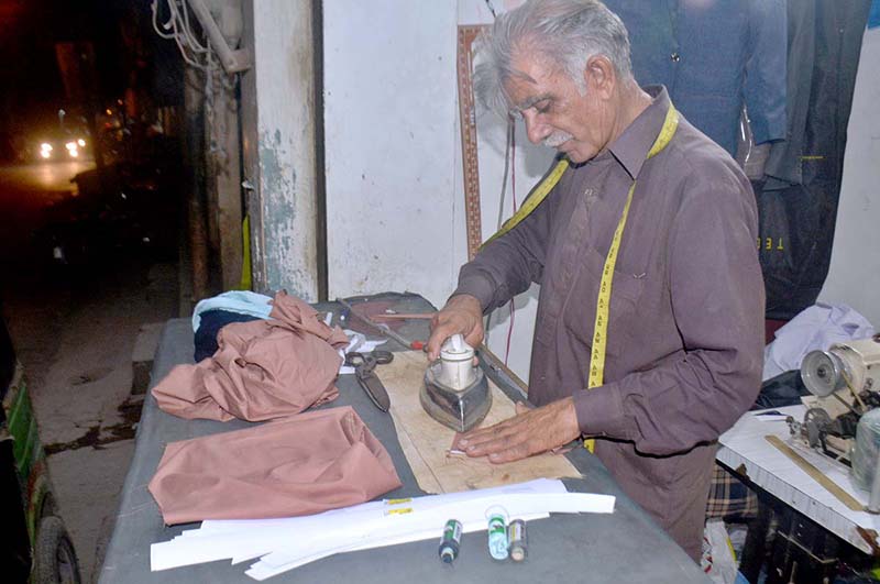 Tailors stitching clothes for customers at Urdu Bazar for upcoming Eid-ul-Fitr