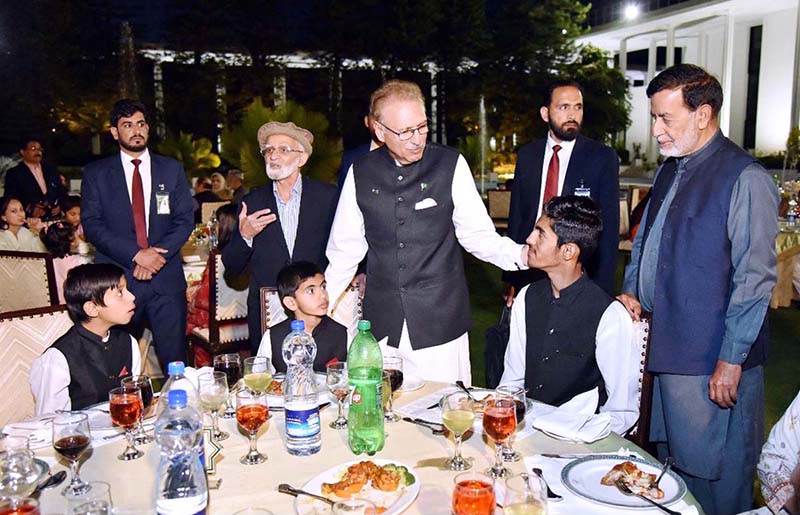 President Dr. Arif Alvi talking to orphan children from different organizations at the Iftar Dinner hosted by him on the occasion of Orphans Day, at Aiwan-e-Sadr