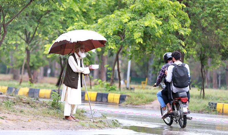A man on the way under cover of umbrella during rain that experience in twin cities