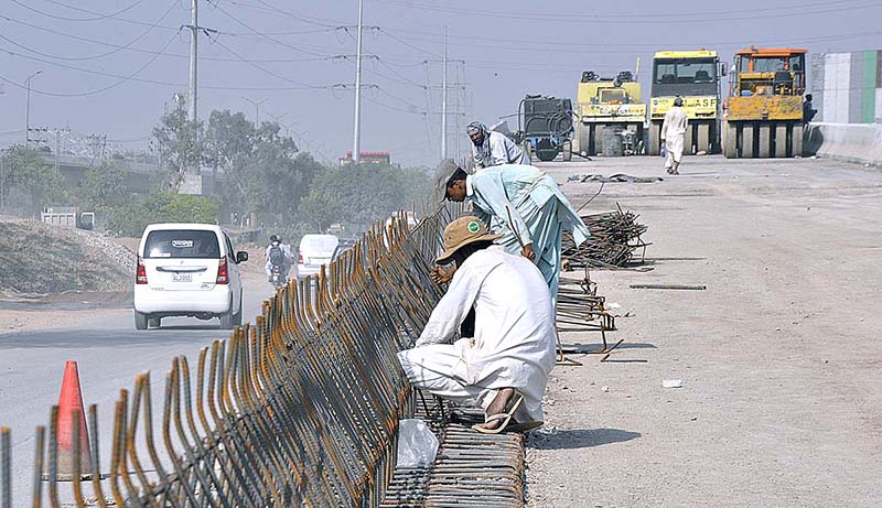Labourer busy in construction work of bridge at IJP Road during development work in the Federal Capital