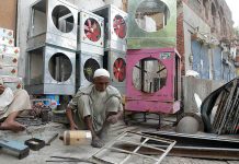 A worker is preparing a room cooler in Golmandi