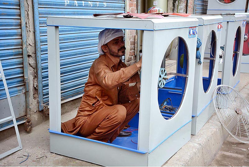 A worker busy in preparing room coolers at his workplace as demands increased during summer season