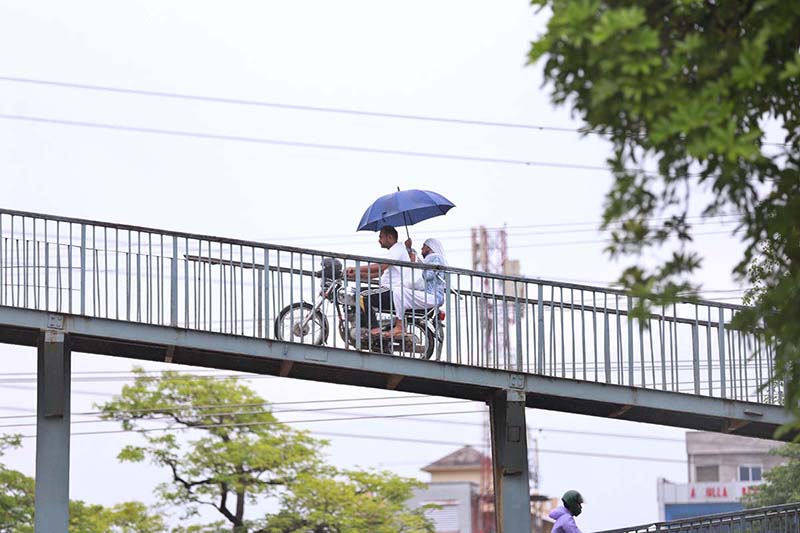 A man on the way under cover of umbrella during rain that experience in twin cities