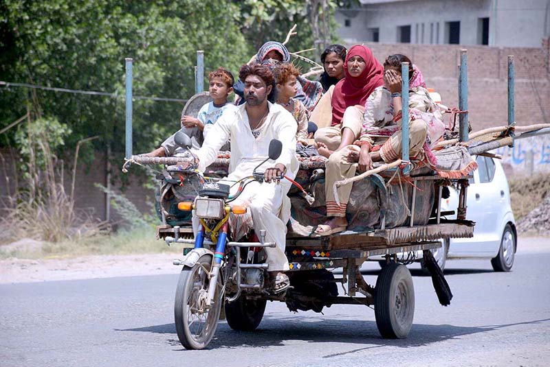 Gypsy Family are traveling on the tricycle rickshaw heading towards their destination