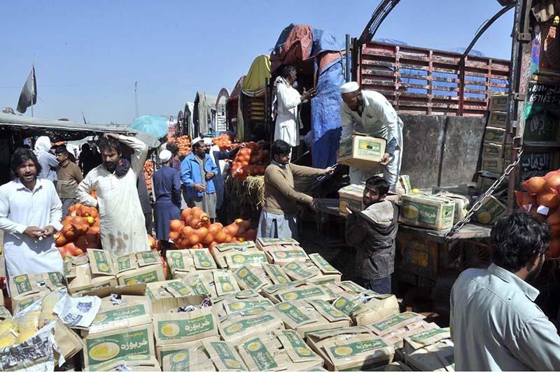 People purchasing fruits displayed by vendors at Fruit Market